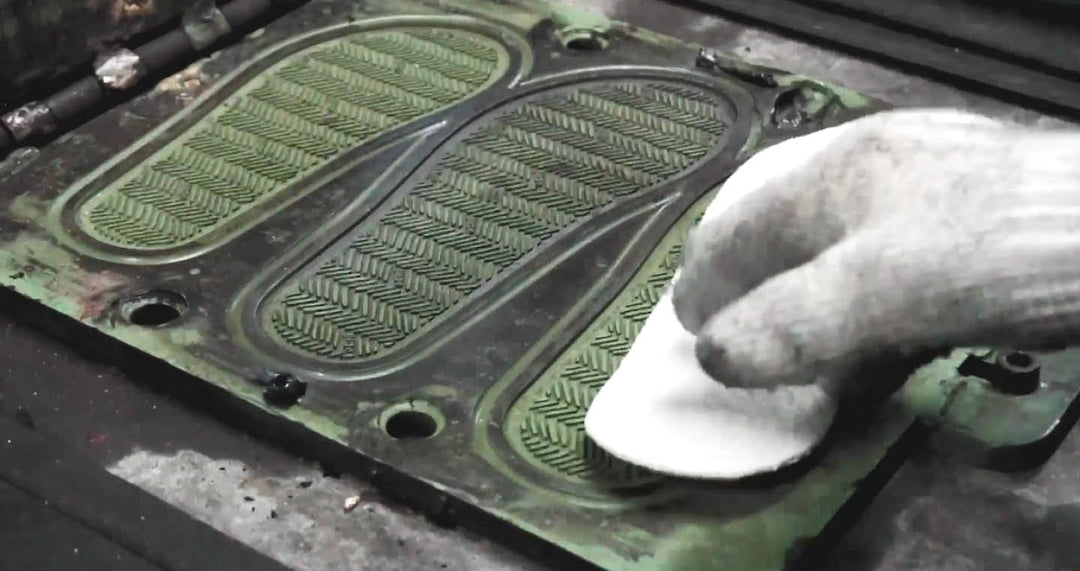 Picture of middle of flip flop making process, specifically the soles